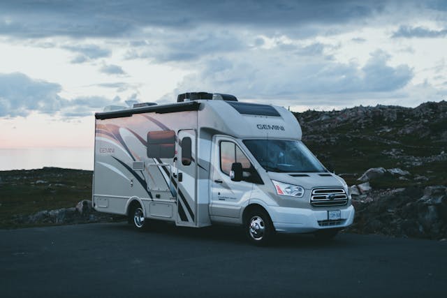 a-white-ford-transit-parked-on-a-vacant-lot